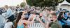 A lively concert crowd enjoying the music, with family and friends raising their glasses for a toast at the Park Royal Beachside Patio.